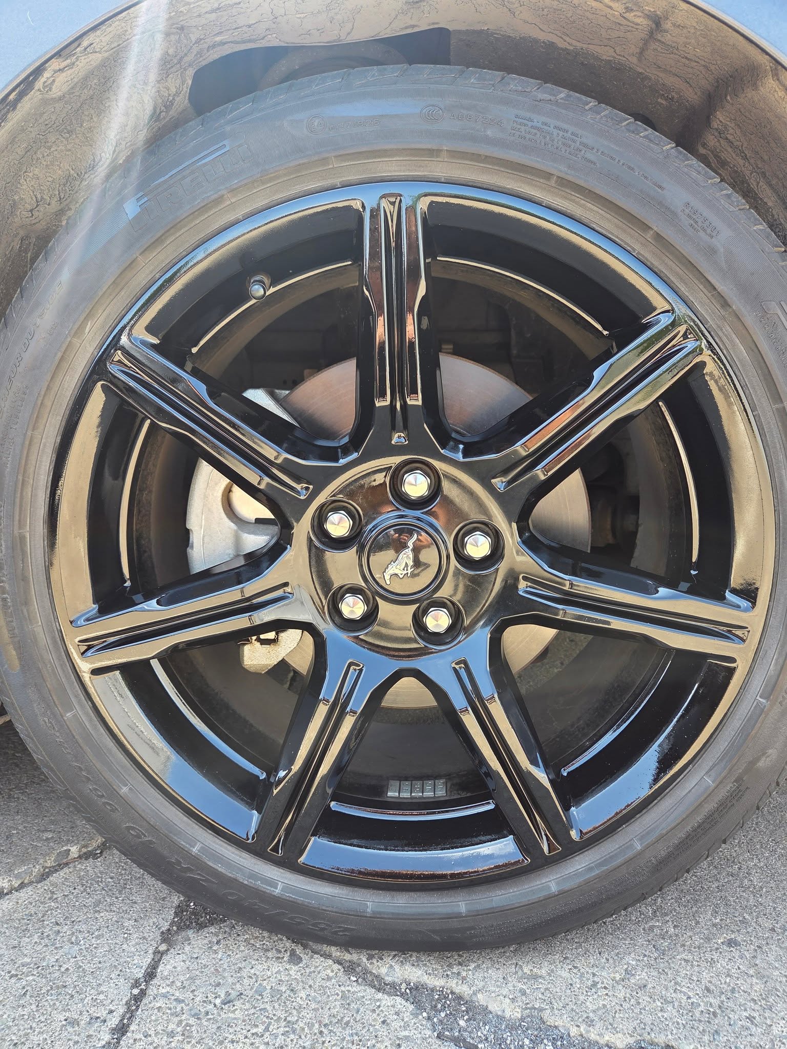 Ford Mustang wheel after curb rash repair and gloss black refinish