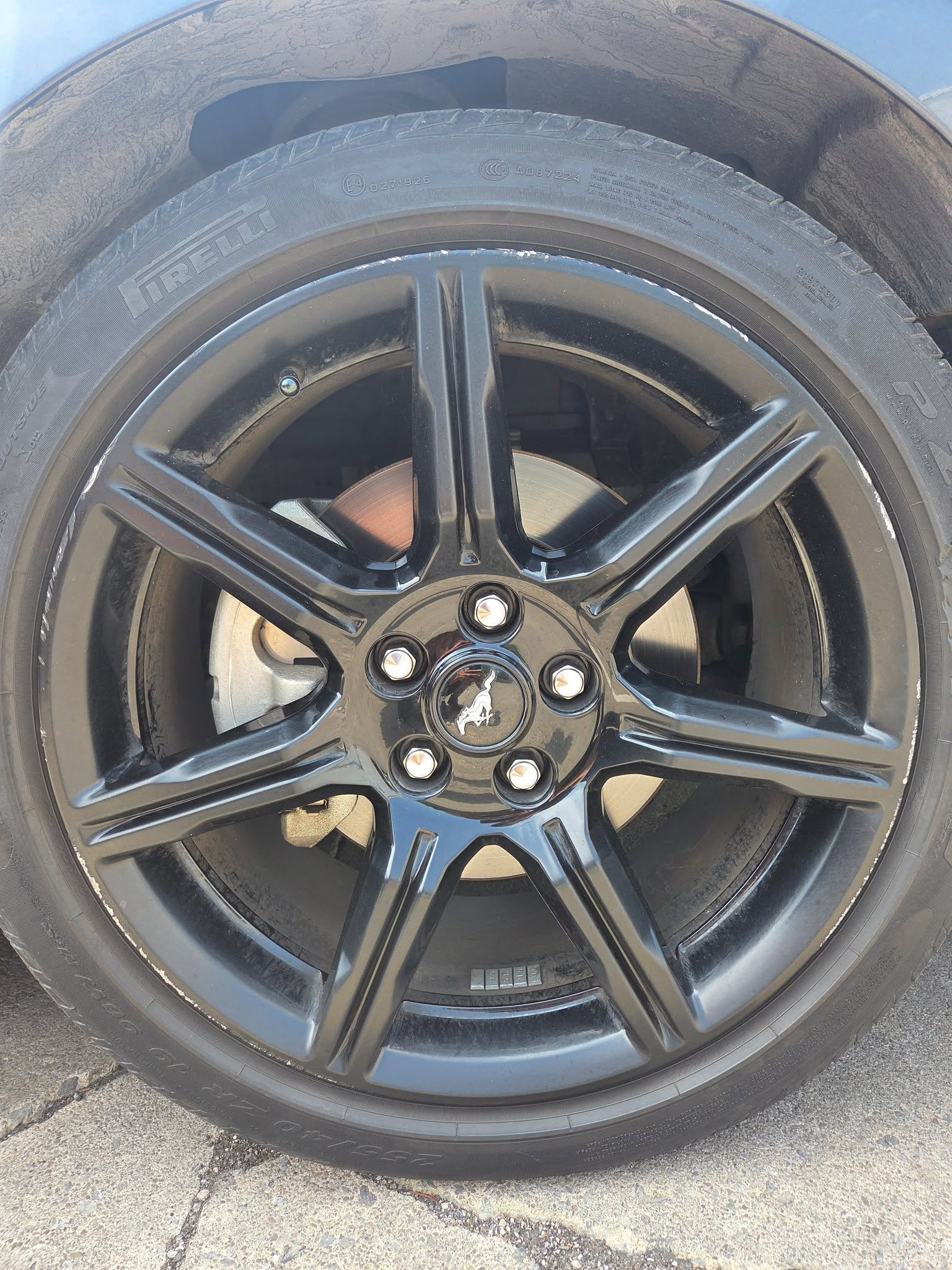 Ford Mustang wheel before repair, curb rash on the spokes